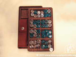 Mancala game, pieces, and storage case