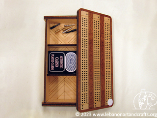 Cribbage board, pegs, playing cards, and storage case