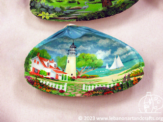Lighthouse scene painted on a shell