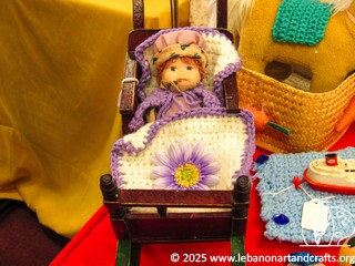 Doll with crocheted outfit and bedding